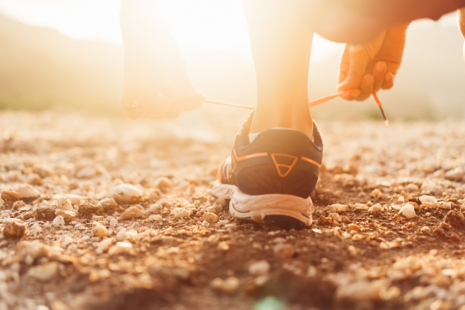 Person Tying Running Shoe